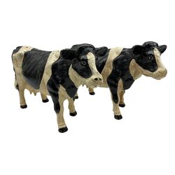 Pair of painted cast iron figures in the form of Friesian cows H21cm