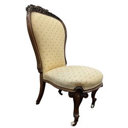 Victorian rosewood framed bedroom chair, pierced and scrolled floral carved cresting rail over seat and back upholstered in yellow floral fabric, scroll carved cabriole supports terminating in ceramic castors W49cm