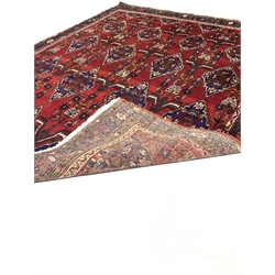 Iranian Neynz rug, red ground with multiple stylised lozenge decorated field