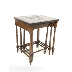 20th century mahogany nest of three tables, each table having a leather covered top decorated with an impressed design, raised on turned supports and stretchers
