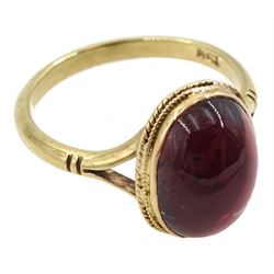 Gold single stone oval cabochon garnet ring, stamped 9ct