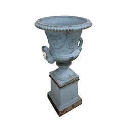 Late 19th century cast iron centre-piece painted urn planter, the moulded top over relief frieze decorated with scrolling garlands and flowerheads,  the twin handles with masks flanked by gadroon patterns, raised on plinth base