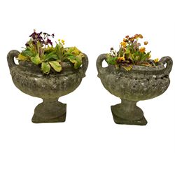 Pair of 19th century sandstone Campana type garden urn planters, on later composite stone plinths 