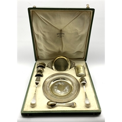 French silver and parcel gilt christening set comprising a circular plate with chased leaf decoration D20cm, dessert spoon and fork, egg spoon, double ended egg cup, napkin ring, beaker H8cm and a shallow circular bowl with flattened handles 18cm 23oz.  Tooled green  fitted plush lined case inscribed ' Boin-Taburet Orfevre, Rue Pasquier .3, Paris.   The original recipient of this set was born in 1899 and then by descent