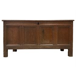 18th century oak coffer or chest, the rectangular hinged top with moulded edge and four panels, interior fitted with candle box, the sides all panelled, raised on rectangular supports with carved fluting and reeding
