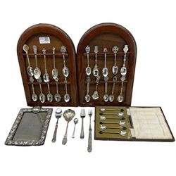 Embossed upright table photograph frame, unmarked but tests as silver, aperture 14cm x 10cm, set of six silver bead knop coffee spoons, twenty English and Continental souvenir spoons and other items