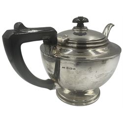 Silver three piece tea set of circular form with a short pedestal foot, the teapot with black handle and lift Birmingham 1938 Makers mark TS