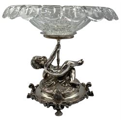 French silver-plated centrepiece by Christofle, modelled as a reclining cherub supporting the circular cut glass bowl with flared petal rim, the circular base cast with trailing foliage on four swept feet, stamped Christofle, H23cm x W25cm 