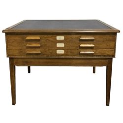 Abbess - Mid-20th century oak plan chest, the inset and projecting top over three long shallow drawers, raised on squared tapering supports  