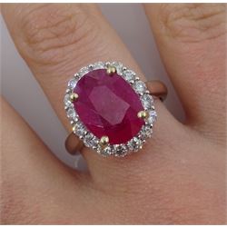 White gold oval ruby and round brilliant cut diamond cluster ring, stamped 18K 750, ruby approx 3.75 carat, total diamond weight approx 0.40 carat