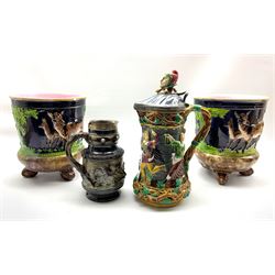 Victorian Minton majolica Tower jug with relief moulded decoration, the hinged cover with jester finial H33cm, a pair of majolica jardinieres decorated with deer in relief H26cm and a stoneware jug decorated with a boar hunting scene with silver collar H20cm (all with damage and/or restoration)