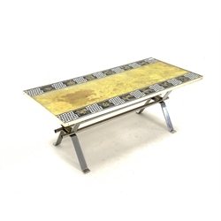 mid 20th century glass toped coffee table, decorated with the signs of the Zodiac, raised on chromed steel base, 51cm x 118cm, H42cm