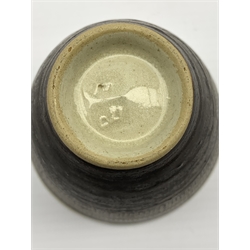 Dame Lucie Rie D.B.E (1902-1995) a stoneware beaker decorated to the exterior with sgraffito lines in a manganese glaze over off white, impressed seal mark, H7.5cm x D8cm