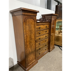 Victorian mahogany combination wardrobe, with a central bank of six drawers flanked by two full length arched panelled doors enclosing interiors fitted for hanging, raised on plinth base, W240cm, H205cm, D68cm