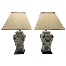 Pair of table lamps of square section form, incised and painted with butterflies against a plain ground, upon square hardwood base, including shade H54cm 