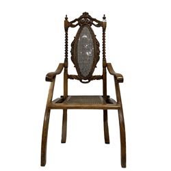 19th century walnut folding campaign chair, the carved cresting rail over bergere back and seat panel, raised on squared supports  