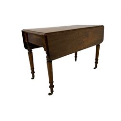 19th century mahogany drop-leaf table, rectangular top with rounded corners fitted with single drawer, raised on turned supports with brass castors