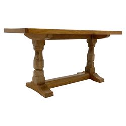 'Mouseman' oak coffee table, rectangular adzed top on octagonal supports, one carved with mouse signature, sledge feet joined by floor stretcher, by Robert Thompson of Kilburn