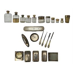 Extensive early 20th century silver and silver gilt ladies travelling toilet set, each piece engraved with a coronet and initials M StO comprising various etched glass and silver mounted bottles and jars, scent bottles, mantel clock, curling tongs heater, writing box containing stamp box, inkwell and vesta compartment, rectangular box, manicure implements, London assay, various dates circa 1910, Maker of most of the items Albert Barker, some items marked New Bond St, London. Provenance:  From the Estate of the late Dowager Lady St Oswald