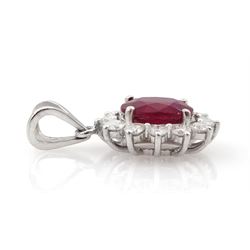 18ct white gold oval cut ruby and round brilliant cut diamond cluster pendant, ruby approx 0.75 carat, total diamond weight approx 0.40 carat