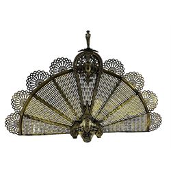 Early 20th century brass 'Peacock' fire screen, with nine fretwork fan shaped panels and scrolling acanthus and pierced cast frame, H60cm x W91cm 
