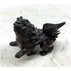 Small Japanese bronze lion with one raised paw L8cm and three 19th century carved wood netsukes