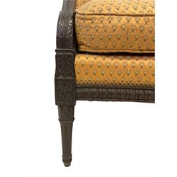 Hepplewhite design mahogany framed two seat settee, the serpentine top with carved applied acanthus leaf arm terminals, upholstered in floral patterned yellow gold fabric with sprung seat, the bow-front with reeded frieze rail, raised on turned and fluted supports