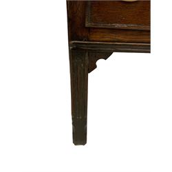 George III country oak dresser base, rectangular top over panelled sides, fitted with three drawers, and raised on fluted supports