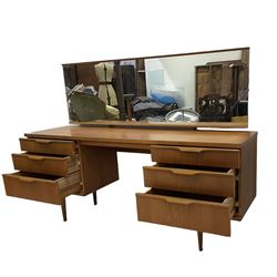Austinsuite - mid-20th century teak dressing table, raised mirror back, fitted with seven graduating drawers, on cylindrical tapering supports