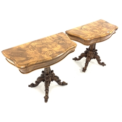  Pair Victorian well figured walnut serpentine card tables, the fold over revolving tops revealing brown crushed velvet playing surfaces, each raised on pedestal and four scroll and leaf carved splayed supports terminating in recessed brass castors, stamped 'Loach & Clarke's Patent' W94cm, H75cm, D48cm  