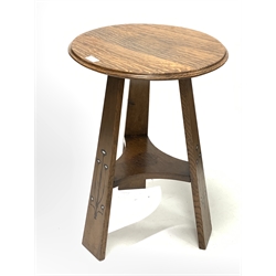 Arts & Crafts oak table by E.G. Punnett and retailed by Norman & Stacey - circular top with moulded edge over three tapered supports with ebonised and metal inlay