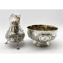 Victorian silver cream jug with embossed floral decoration and engraved with a crest on shaped supports H13cm London 1856 Maker Henry Holland and a similar sugar bowl D13cm London 1850 Maker Daniel and Charles Houle 15oz