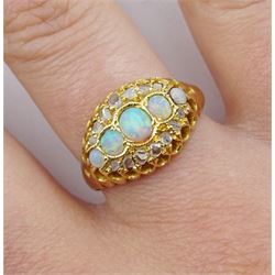 Early 20th century five stone graduating opal ring, with diamond surround, stamped 18ct