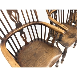 Set four early to mid 19th century elm and ash Windsor armchairs, having hoop, spindle and pierced splat backs over shaped seats and raised on ring turned supports united by crinoline stretcher