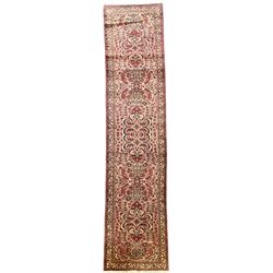 Persian rose ground runner rug, symmetrical pole medallion with interconnecting geometric flower heads, the field decorated profusely with stylised plant motifs, the multi-band ivory border with repeating foliate designs