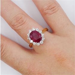 18ct gold oval cut ruby and round brilliant cut diamond cluster ring, hallmarked, ruby approx 3.40 carat, total diamond weight approx 0.65 carat