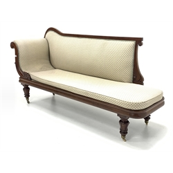 Mid 19th century mahogany upholstered chaise longue, with scrolled floral decoration, squab cushion, raised on tuned and carved supports with brass cup castors