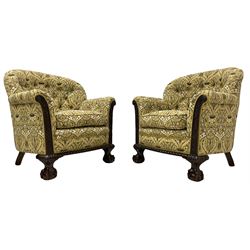 Pair of late 19th to early 20th century mahogany armchairs, upholstered in floral pattern fabric, the scrolled uprights decorated with carved trailing foliage and flowerhead motifs, upholstered seat cushion and sprung seat, gadroon carved lower edge on acanthus carved ball and claw feet