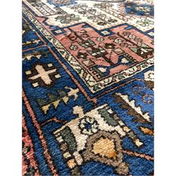 Persian Nahawand ground rug with geometric designs of ivory, blues, greens and reds 200cm x 135cm