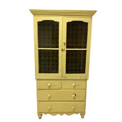Yellow painted kitchen cabinet, the projecting cornice and two glazed doors, opening to reveal four fixed shelves over two long and two short drawers, raised on tuned supports 