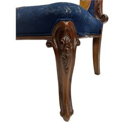 19th century walnut nursing chair, the high back carved with scrolling acanthus leaves, the seat and back upholstered in floral needlework, on cartouche carved cabriole supports with scrolling terminals