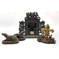 Victorian cast iron miniature fire place, crested by the Royal coat of arms and flanked by fruiting oak, L33cm, pair of cast iron dog form doorstops and another door stop 