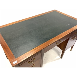20th century mahogany twin pedestal desk, skivered top over one long drawer, two skivered slides and four short drawers, raised on square tapered supports terminating in brass cups, 138cm x 76cm, H76cm
