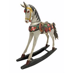 Late 20th century carved wood child's rocking horse, with polychrome painted saddle and stirrups, L105cm