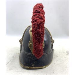 Imperial German Saxon  Model 1867 helmet, blackened leather skull with oak leaf embossed brass comb and red wool crest, brass flat chinscales, lion mask bosses, brass and white metal star helmet-plate mounted with a FJ cypher, H25cm 