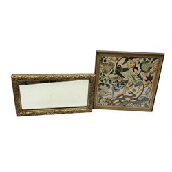 19th century carved giltwood mirror, of rectangular form with scrolling floral and acanthus frame, 59cm x 34cm, together with a stylized embroidered panel, worked in bright threads with exotic birds, a leaping hare and foliage, framed 