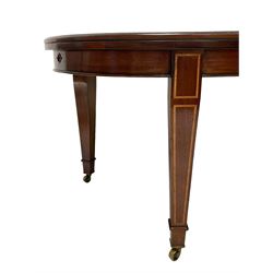 Edwardian inlaid mahogany telescopic extending dining table, moulded oval top with two additional leaves, on square tapering supports with spade feet and brass castors