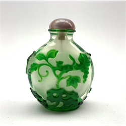 Chinese Peking glass snuff bottle of flat ovoid form, decorated in green glass overlay depicting a squirrel amongst blossoming branches, H8.5cm x W6.5cm