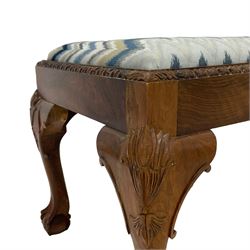 Georgian design square walnut stool, drop-in seat upholstered in patterned blue fabric, carved egg and dart edge raised on cabriole supports with moulded foliate and scroll decoration, on ball and claw feet