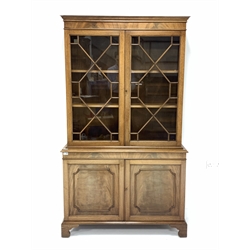  George III style mahogany bookcase on cupboard, moulded cornice above two astragal glazed doors, enclosing two adjustable shelves, panelled cupboard to base raised on shaped bracket feet, W106cm, H185cm, D35cm  